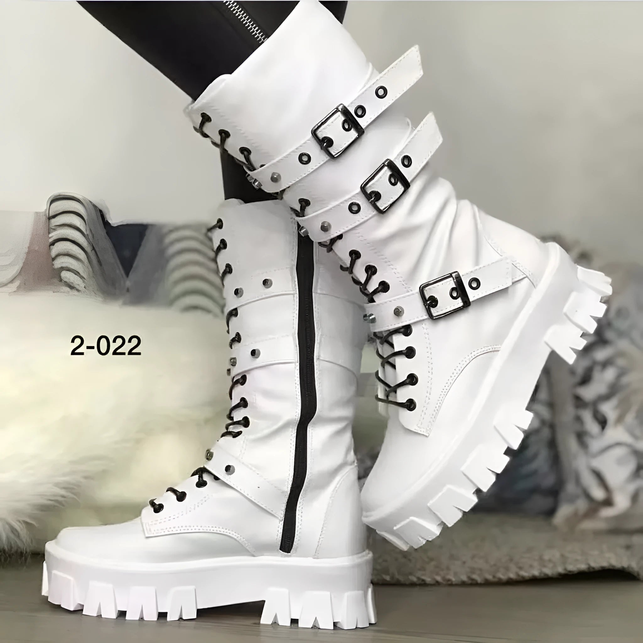 Black women's mid-calf boots with metal buckles and a side zipper on a white background.