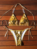 Gold halter lace-up bikini with pearl chain detail on mannequin showing front view