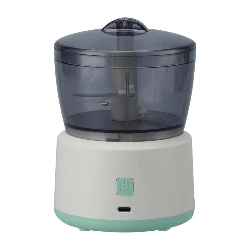 Mini electric meat grinder with transparent 225ml cup and stainless steel blades in light green colour