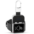 Black Apple Watch keychain power bank with wireless charging pad next to an Apple Watch.