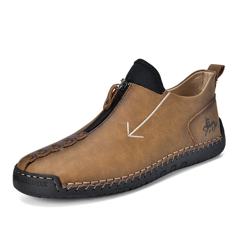 Men's black leather ankle boots with a front zip and round toe on a rubber sole