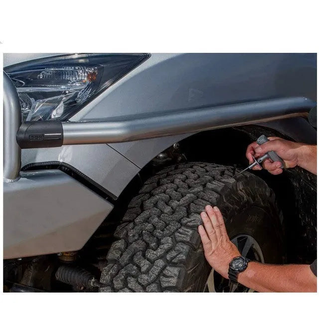 Open case showing emergency car tyre repair tool set with pressure gauge, pliers, and insertion tools.