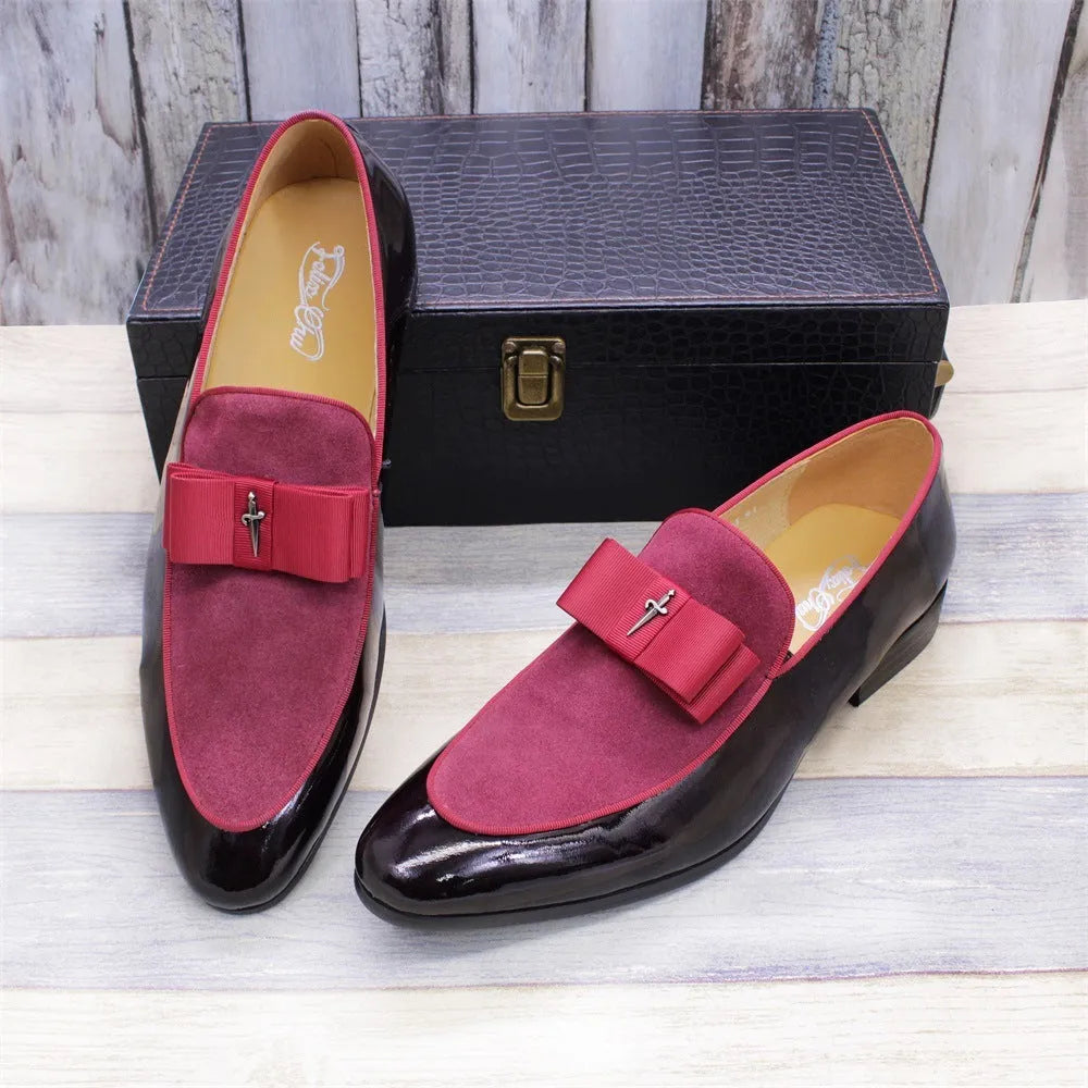 Men's black tassel loafer shoe with matte leather and glossy patent leather detail on a white background.
