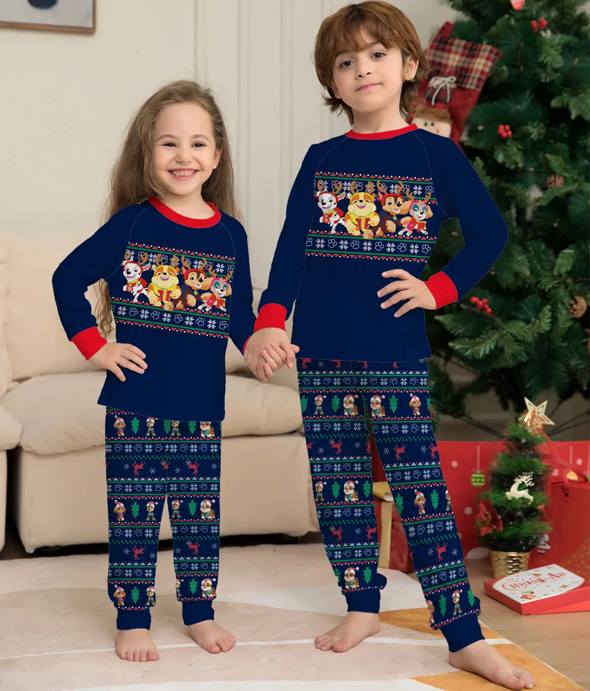 Family wearing matching red plaid Christmas pajamas with deer motif, including parents, children, and a dog.