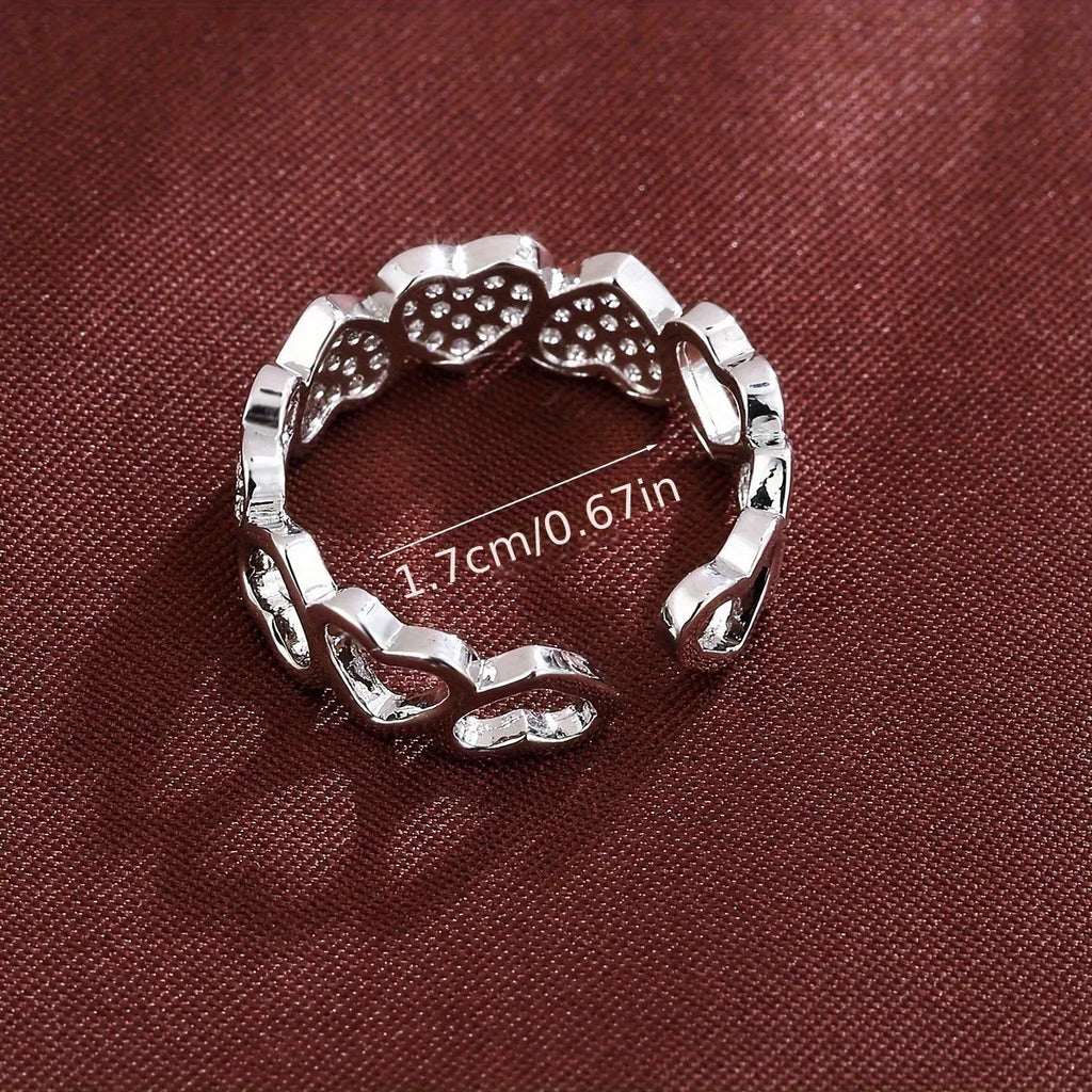 Geometric adjustable opening ring with a love heart detail in a choice of gold or silver tone finish.