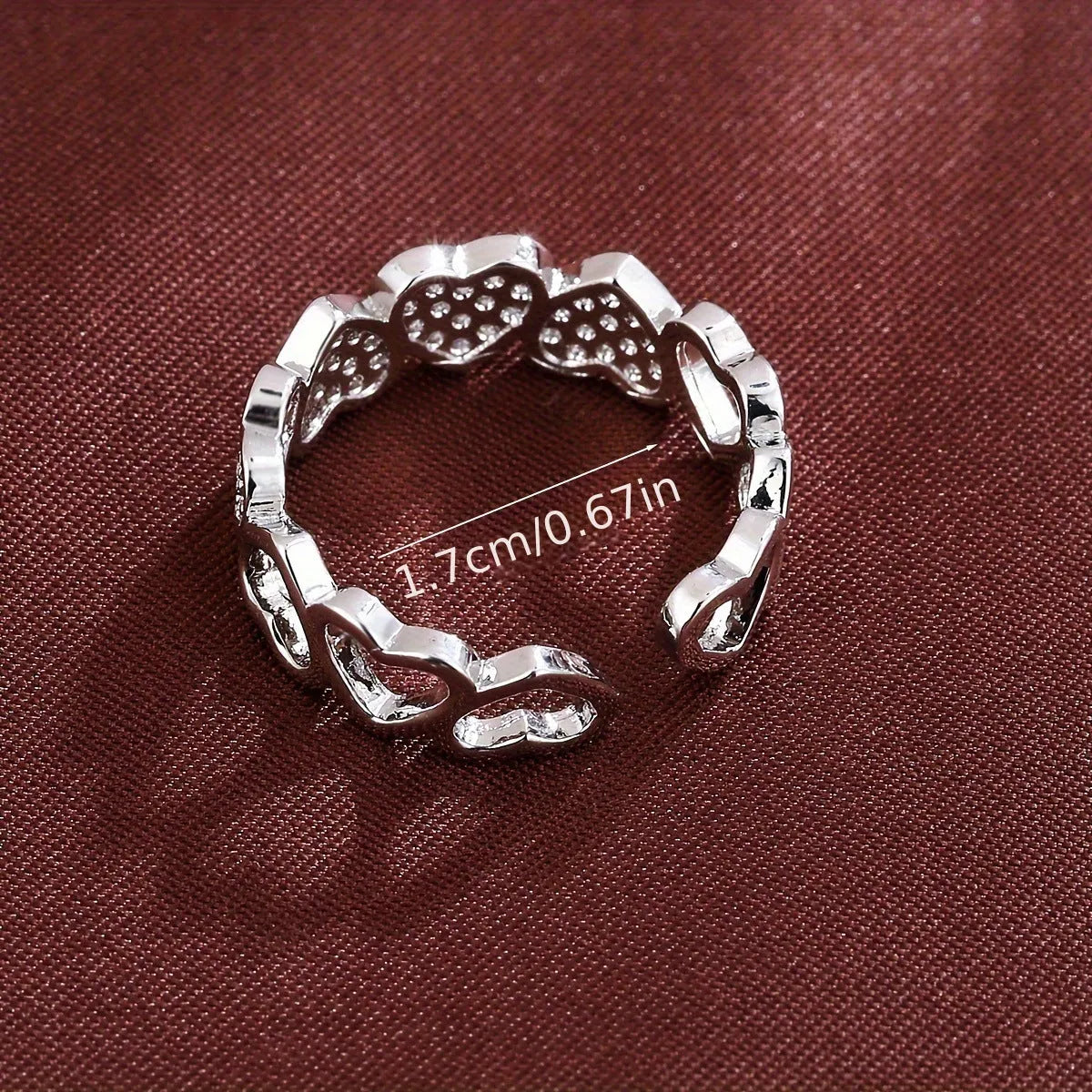 Geometric adjustable opening ring with a love heart detail in a choice of gold or silver tone finish.