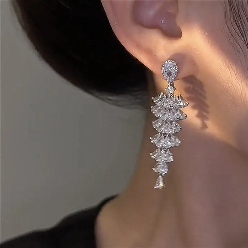 Women's silver pagoda Christmas tree drop earrings with sparkling zircon details on copper.