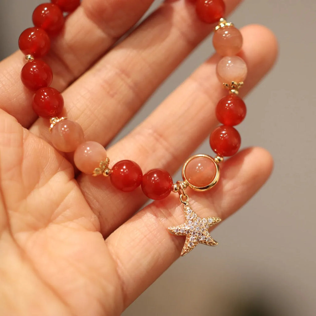 Handmade women's bracelet with 8mm red agate and orange sunstone beads, featuring star and cloud designs.