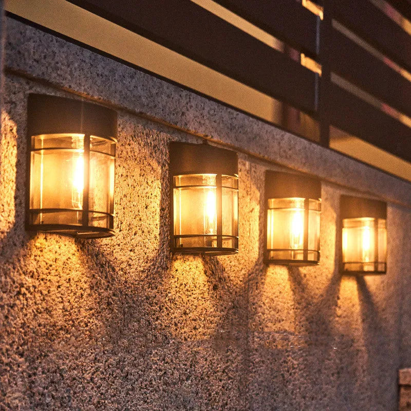 Set of 6 solar-powered outdoor wall lights with warm white illumination mounted on a garden wall