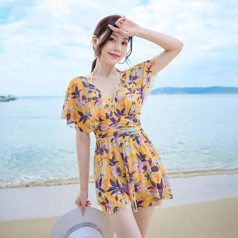 Yellow floral pattern women's one-piece polyester swimsuit on mannequin