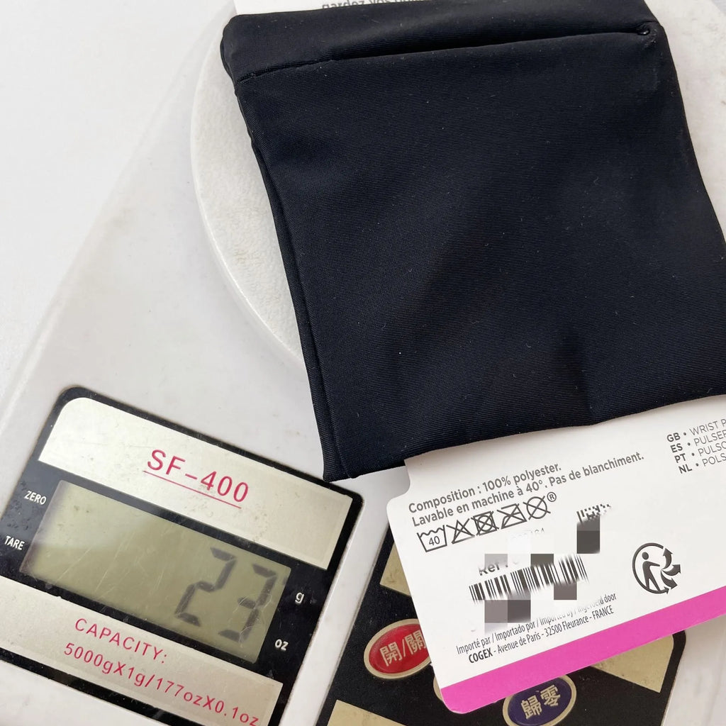 Black wrist sleeve bag with a mobile phone inserted, showing hands-free design on a person's wrist.