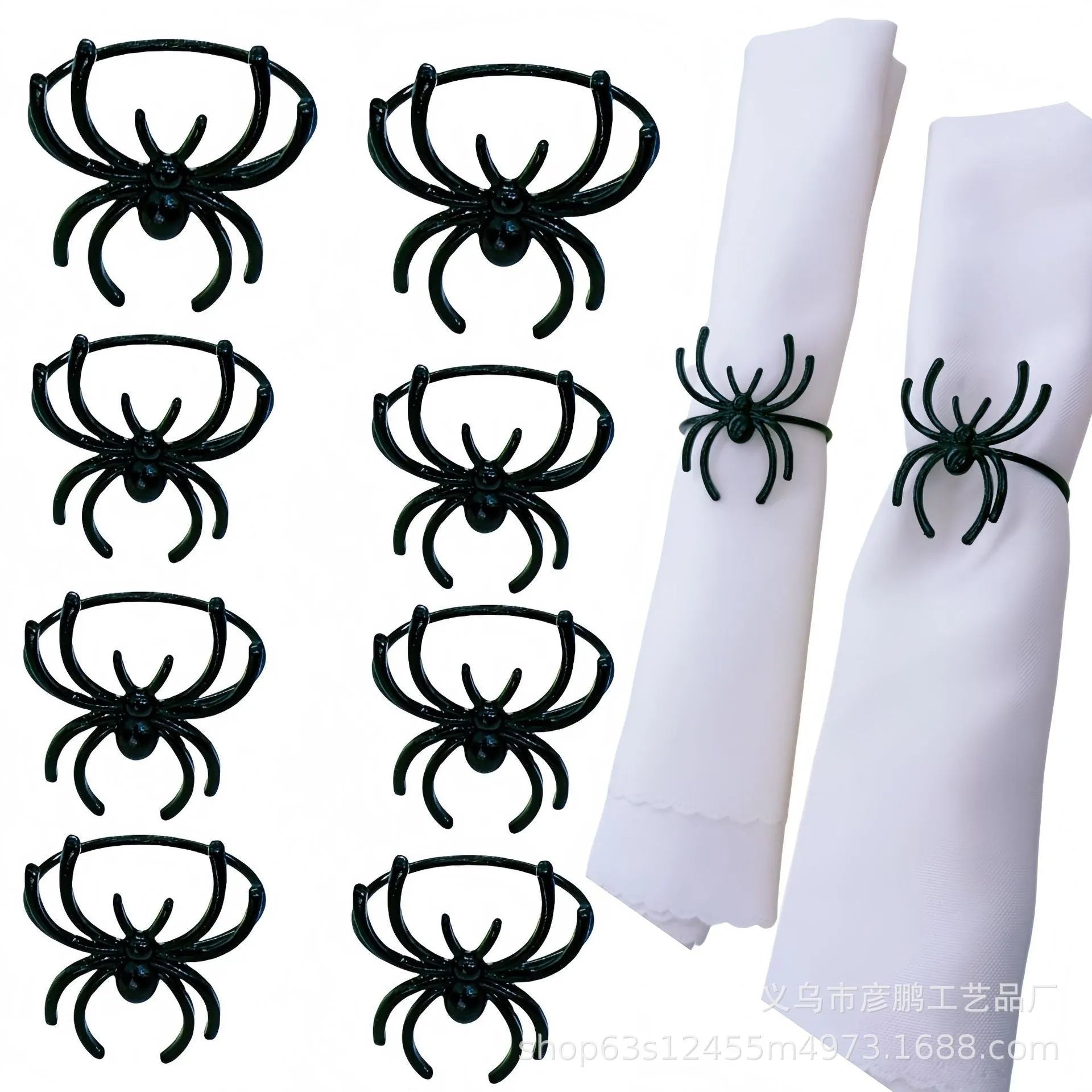 Set of six black alloy spider-shaped napkin rings on a dark tablecloth.