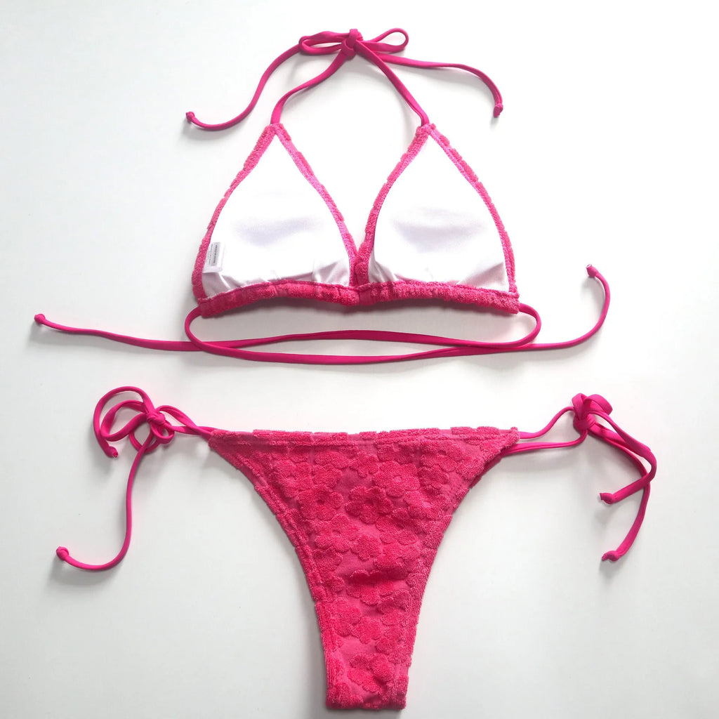 Rose red women's bikini swimsuit showing a three-point lace-up back detail on a mannequin.