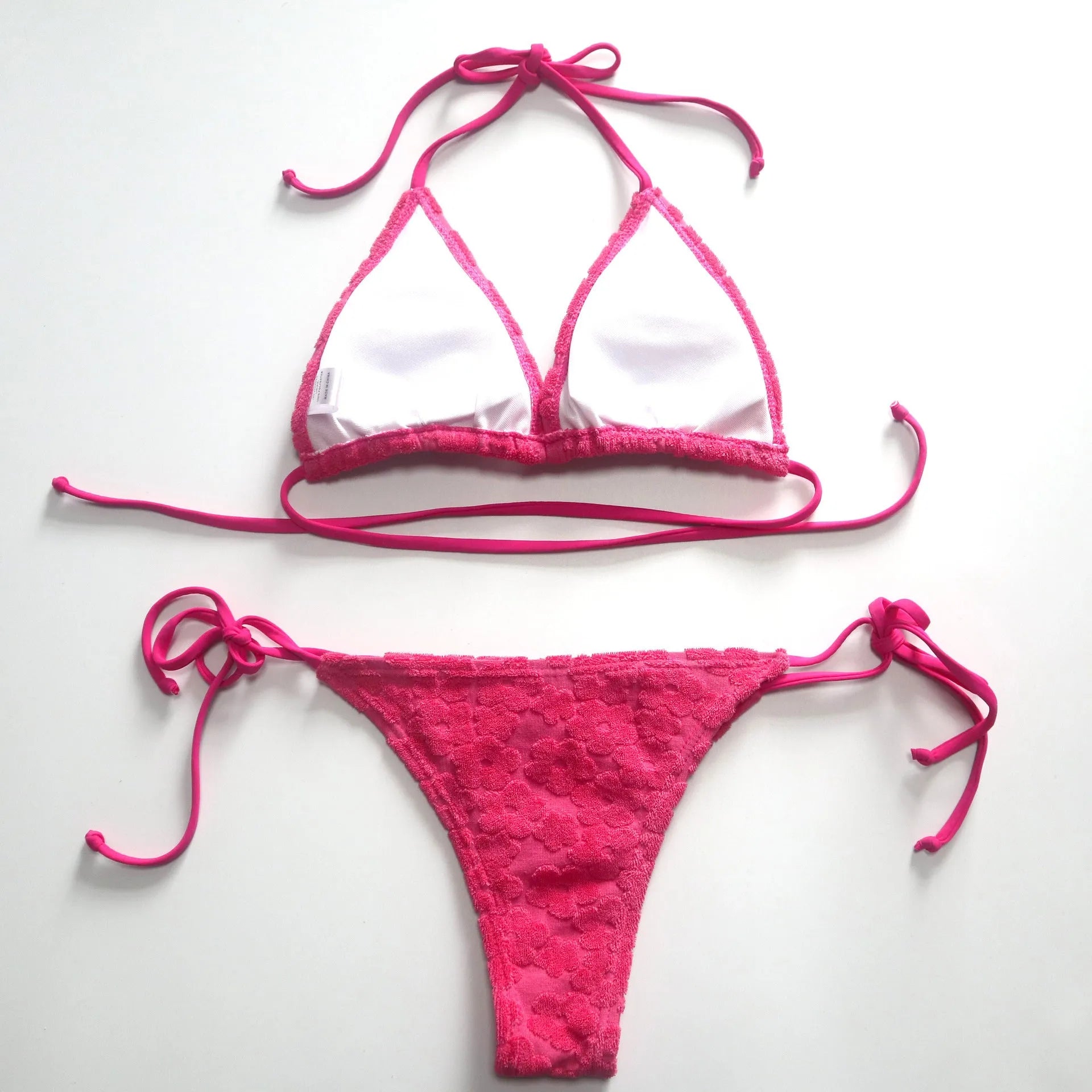 Rose red women's bikini swimsuit showing a three-point lace-up back detail on a mannequin.
