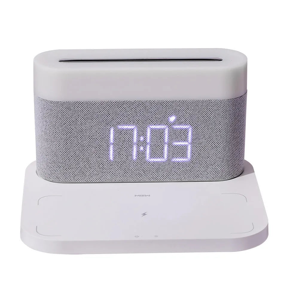 White wireless charging table lamp with integrated alarm clock on bedside table