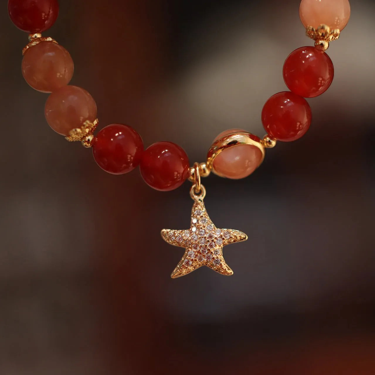 Handmade women's bracelet with 8mm red agate and orange sunstone beads, featuring star and cloud designs.