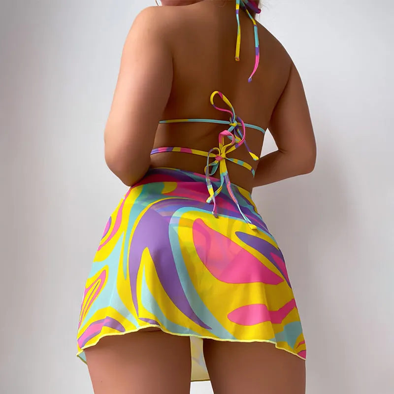 Yellow striped women's halter swimsuit with lace-up front, worn with matching skirt and shorts.