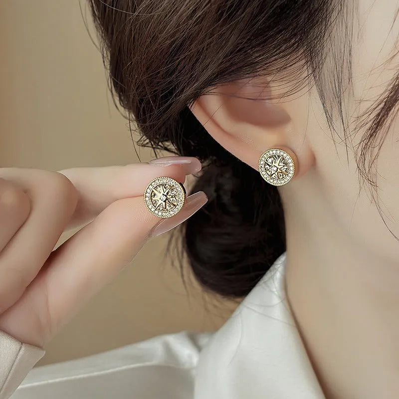 Pair of copper eight-pointed star stud earrings with real gold plating and inlaid zircon