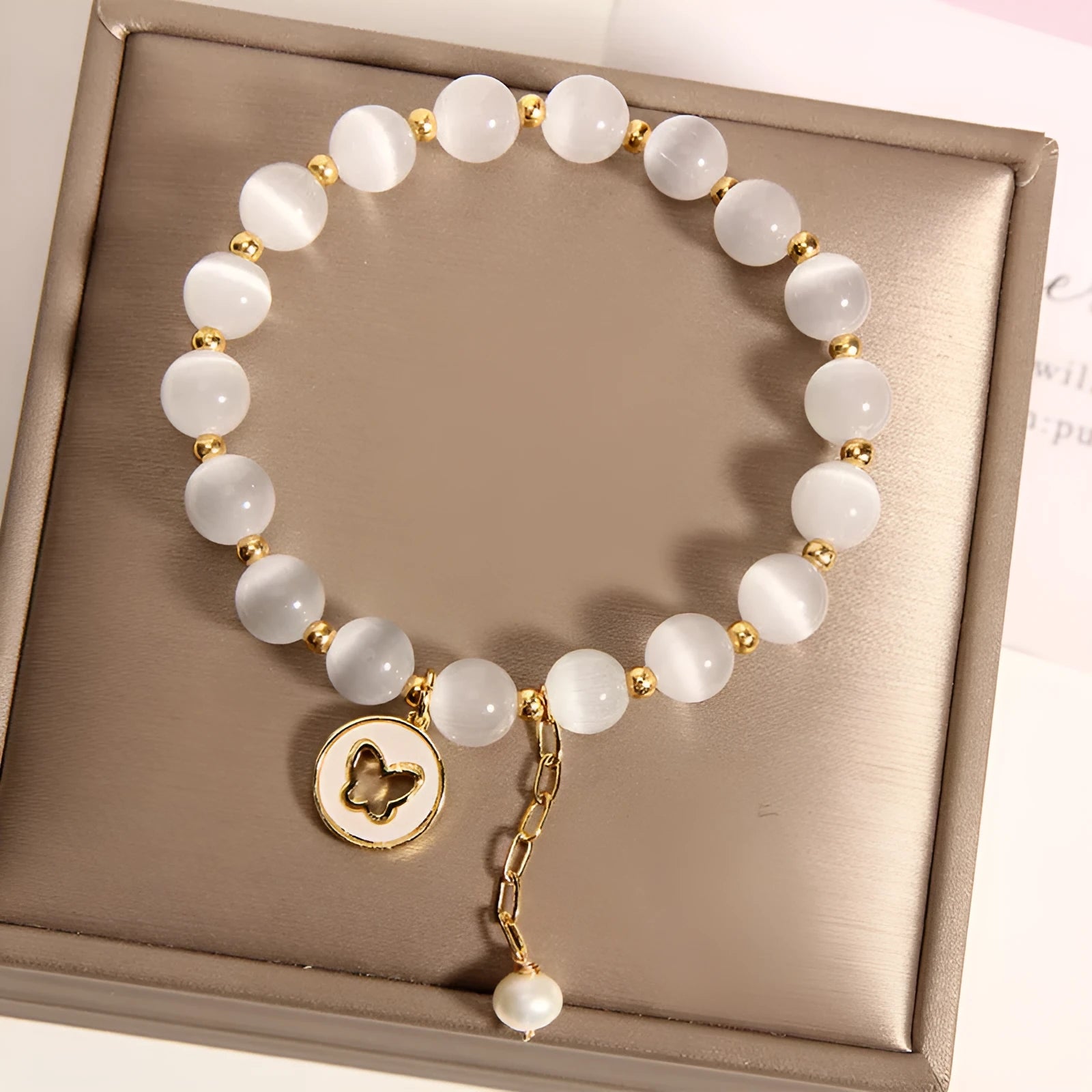 White geometric Cat's Eye crystal bracelet on a wrist, showing its handcrafted Korean-style design.