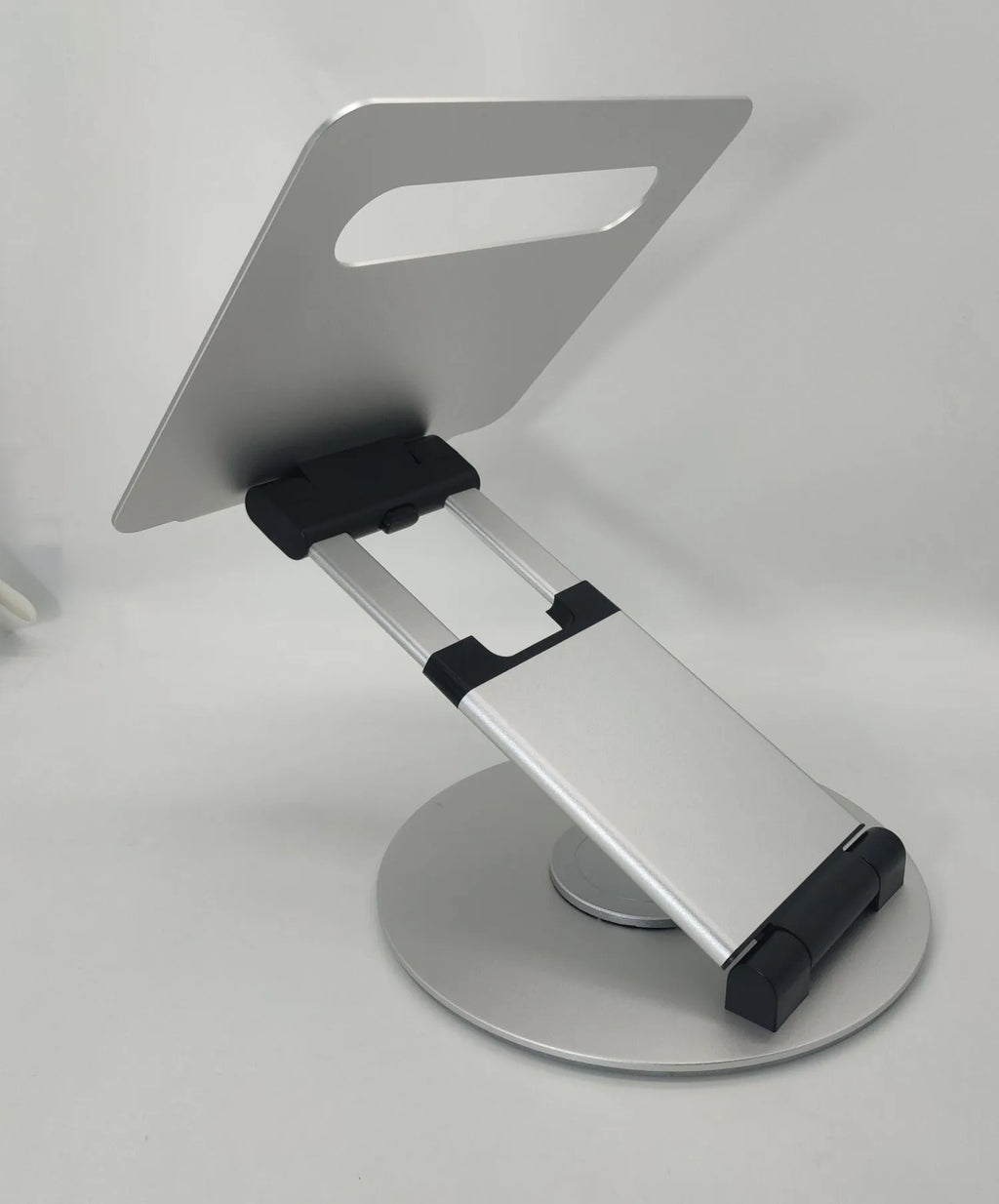 Aluminum alloy laptop bracket with adjustable base and 360-degree rotation on a desk