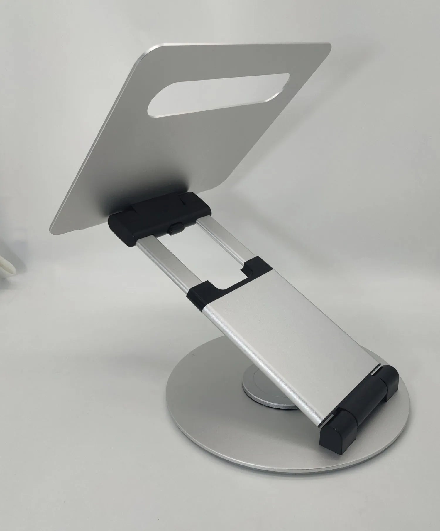 Aluminum alloy laptop bracket with adjustable base and 360-degree rotation on a desk