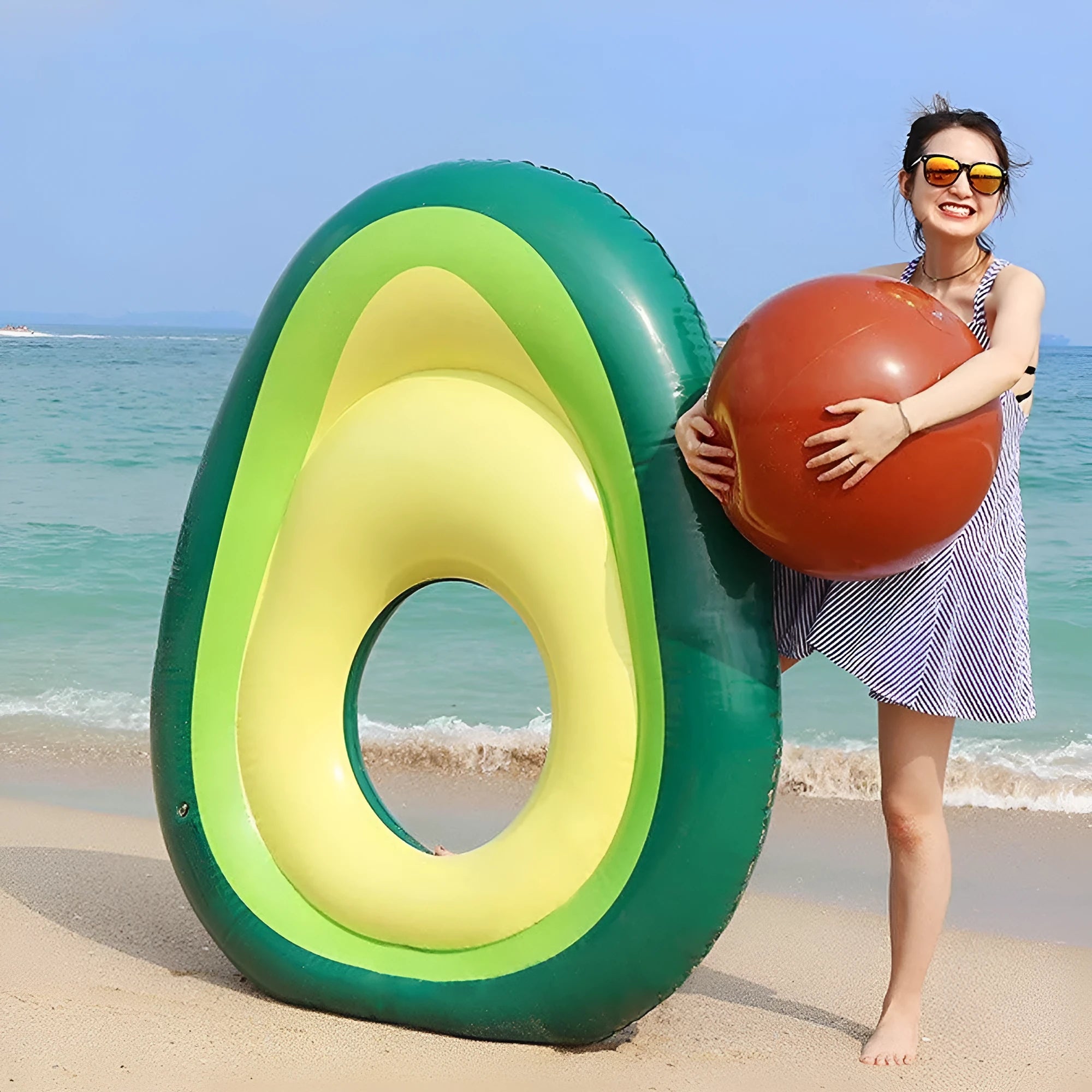 Green avocado-shaped inflatable pool float measuring 169cm long on blue water