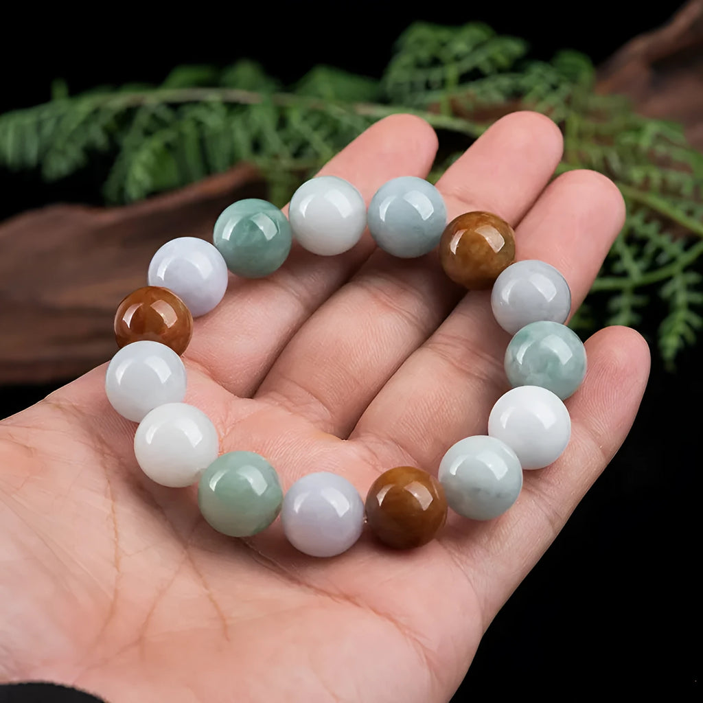 Close-up of a women's bracelet with round 13mm Myanmar jade beads in three colours.