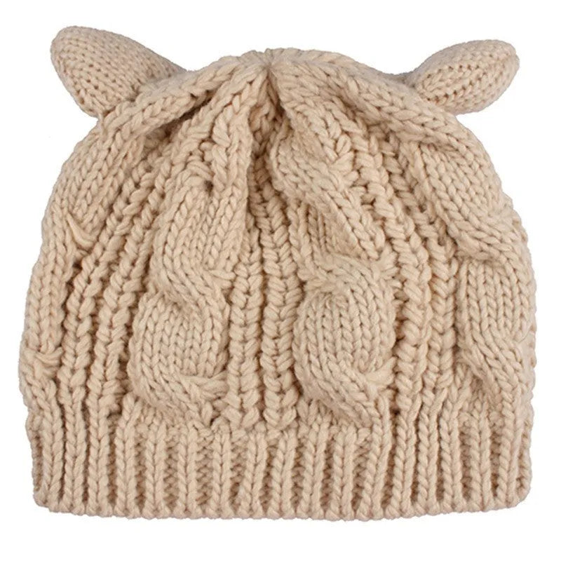 Hand made red knitted winter beanie with 3D cat ears on a mannequin head.