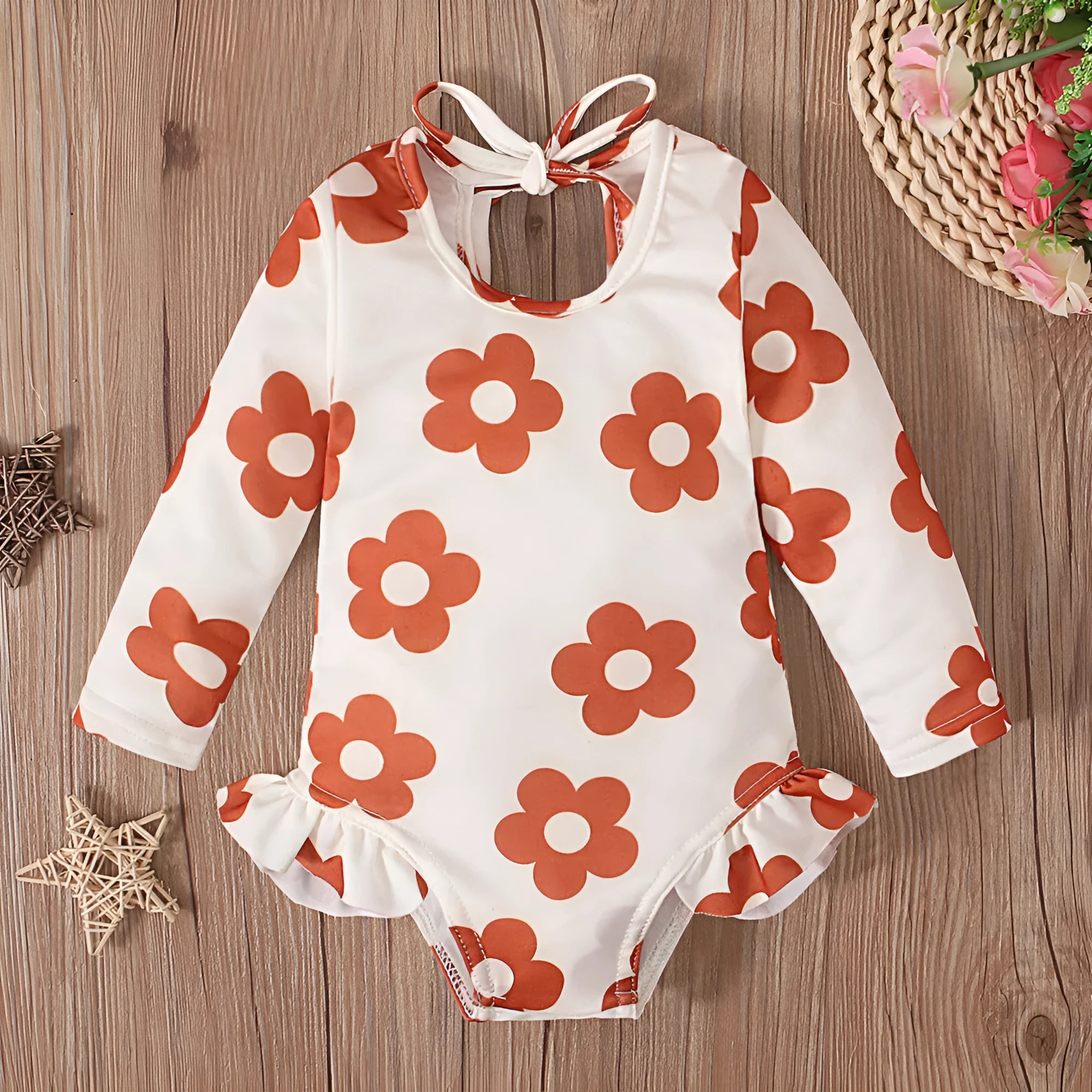 Girls floral print swimsuit with crew neck front and open back in orange colour