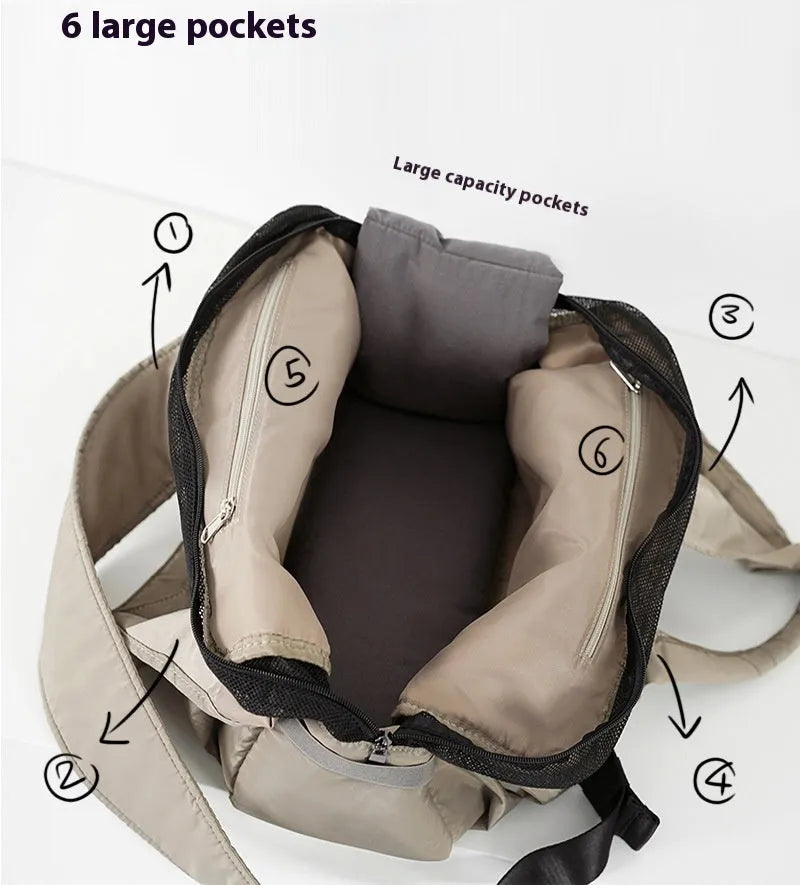 Apricot-colour cloth pet carrier handbag with mesh panels and a shoulder strap.