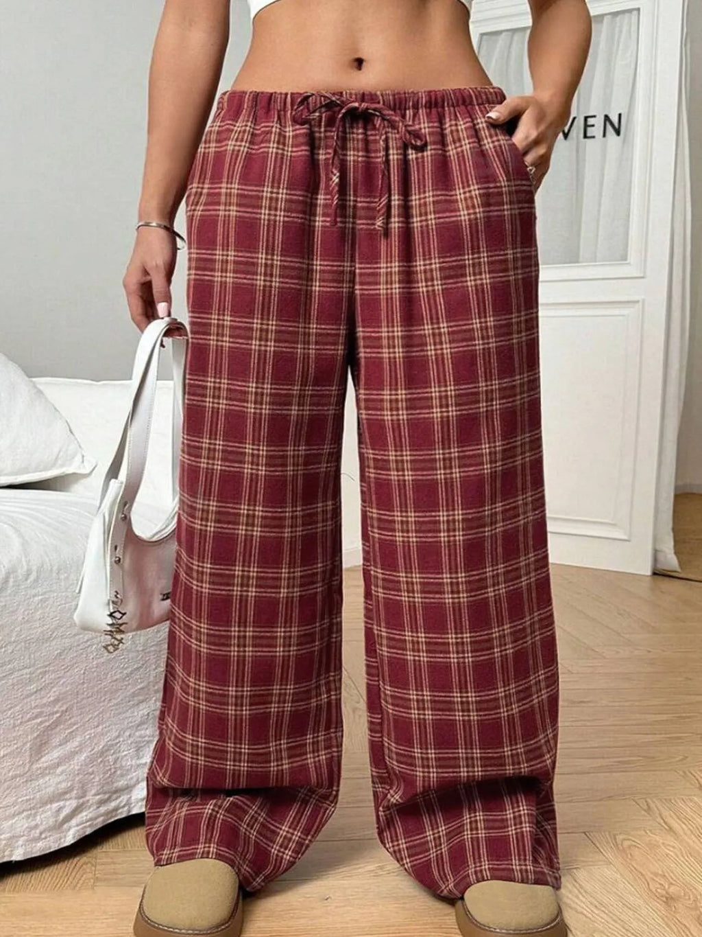 Women's red and blue plaid casual trousers with a drawstring waist and side pockets.