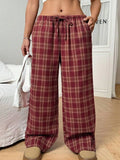 Women's red and blue plaid casual trousers with a drawstring waist and side pockets.
