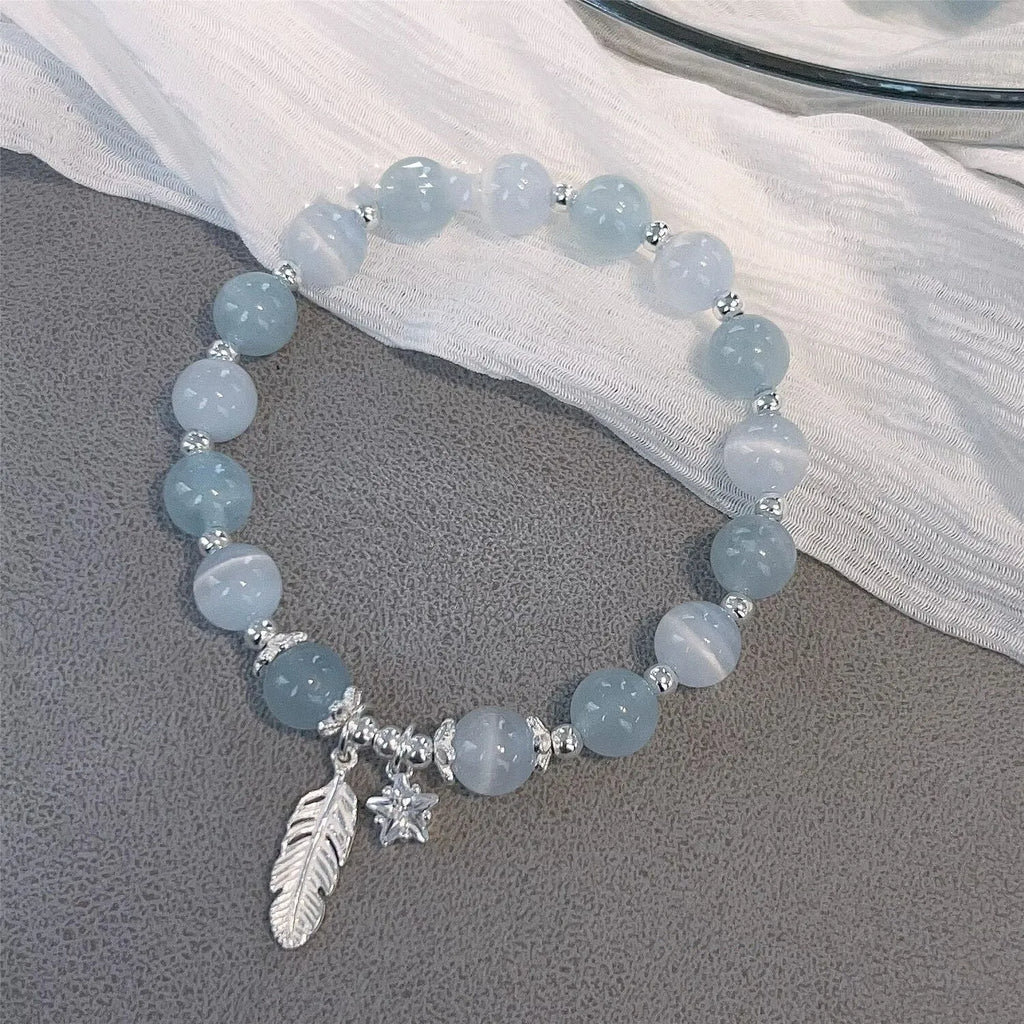 Korean style glass and coloured glaze crystal bracelet in feather XINGX blue moonlight colour with text detailing