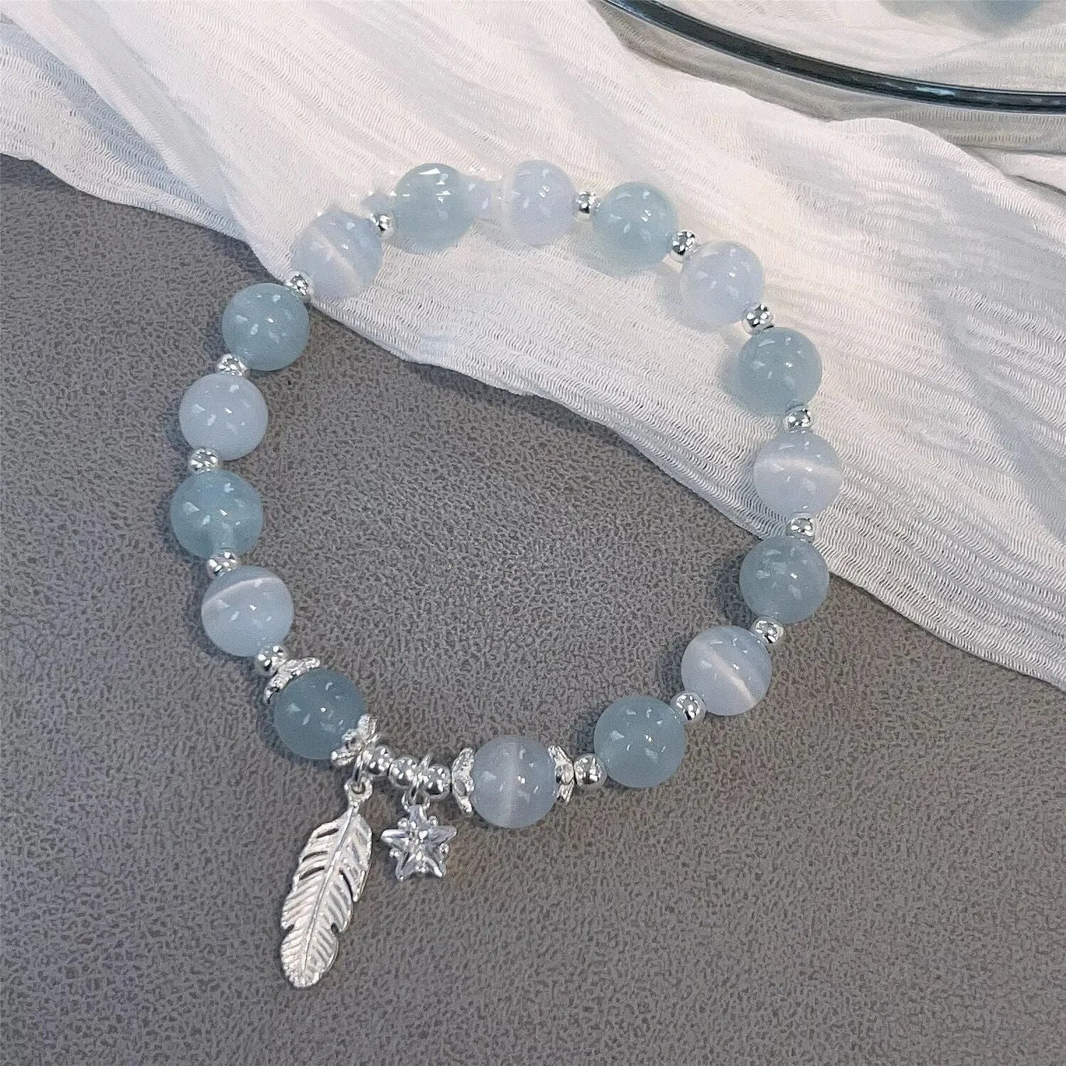 Korean style glass and coloured glaze crystal bracelet in feather XINGX blue moonlight colour with text detailing