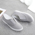 Low-top canvas casual shoes in black, grey, pink, and white colours with flat plastic soles