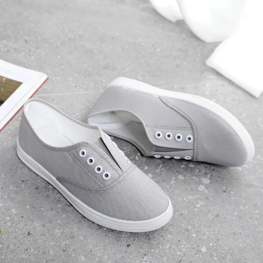 Low-top canvas casual shoes in black, grey, pink, and white colours with flat plastic soles