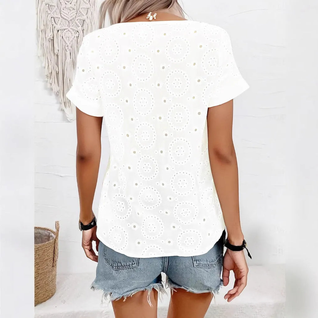 White loose V-neck T-shirt with decorative hollow-out pattern on the short sleeves.
