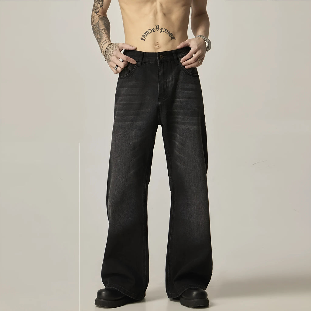 A pair of black loose-fit straight-leg jeans with a retro style on a white background.