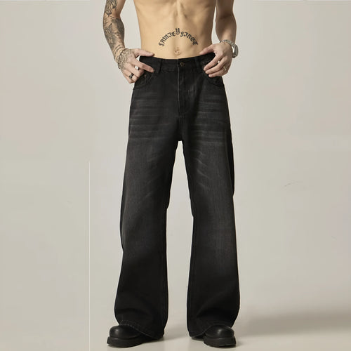 A pair of black loose-fit straight-leg jeans with a retro style on a white background.
