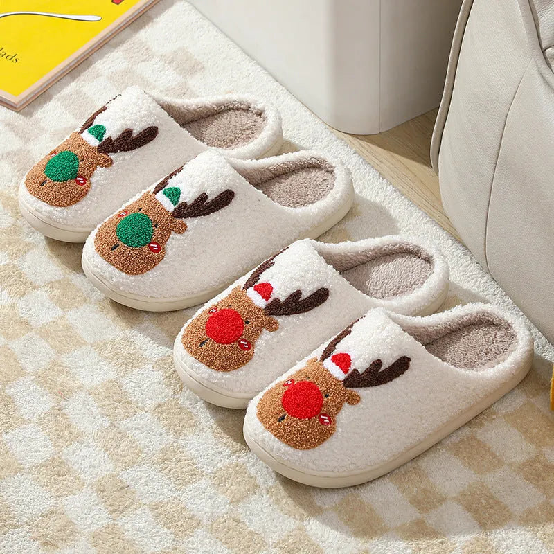 Christmas winter home slippers in red with plush upper and anti-slip sole on a wooden floor