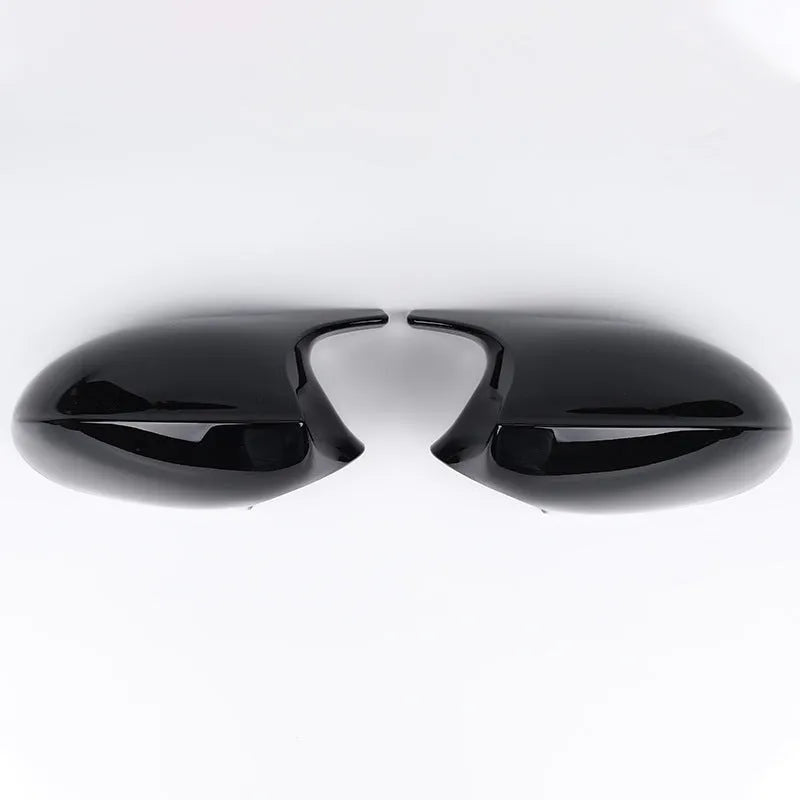 A pair of black ABS plastic rearview mirror shells for a BMW 3 Series E90 car.