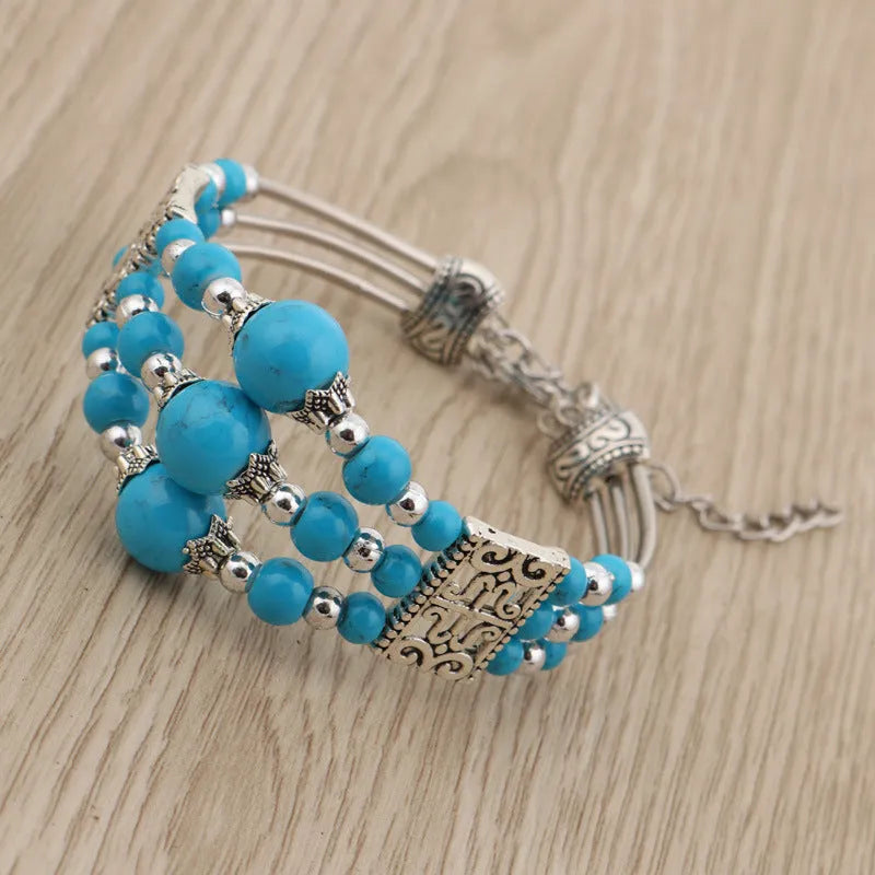 Tibetan style wide bangle bracelet with colourful beads, turquoise tone, tassel detail and electroplated alloy finish