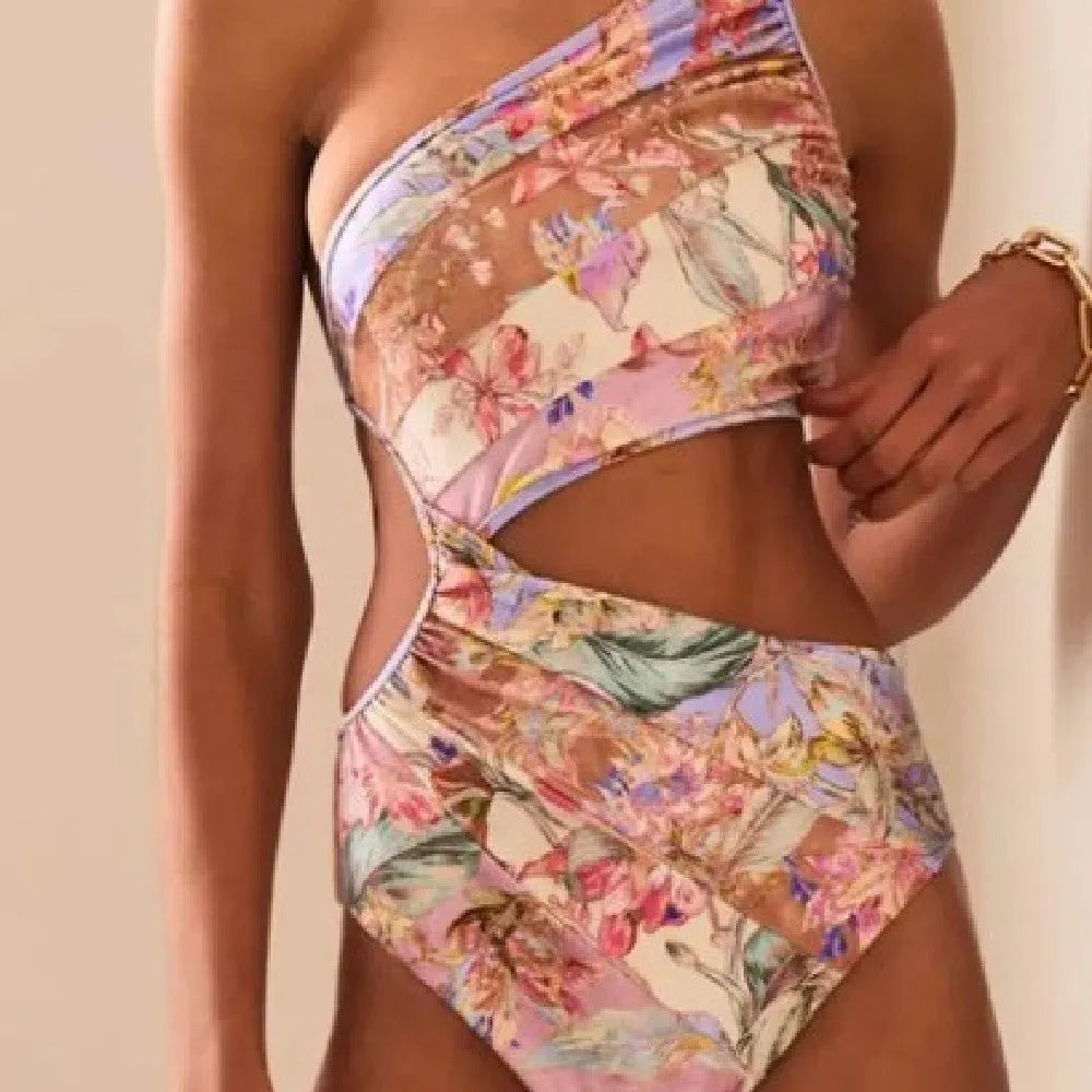 Women's rose gold patterned one-piece swimsuit on hanger