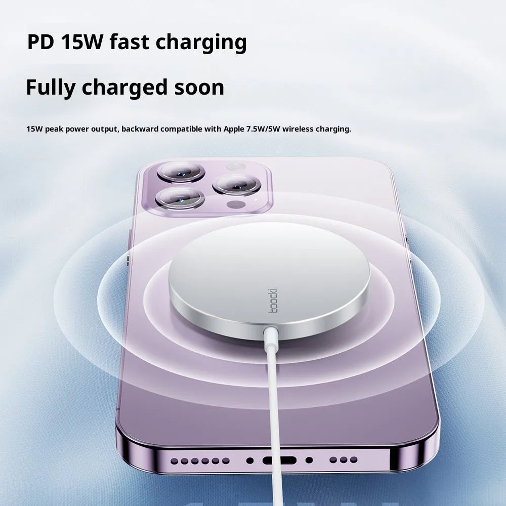 White simulation Apple-style 15W magnetic wireless charger on a table with a smartphone