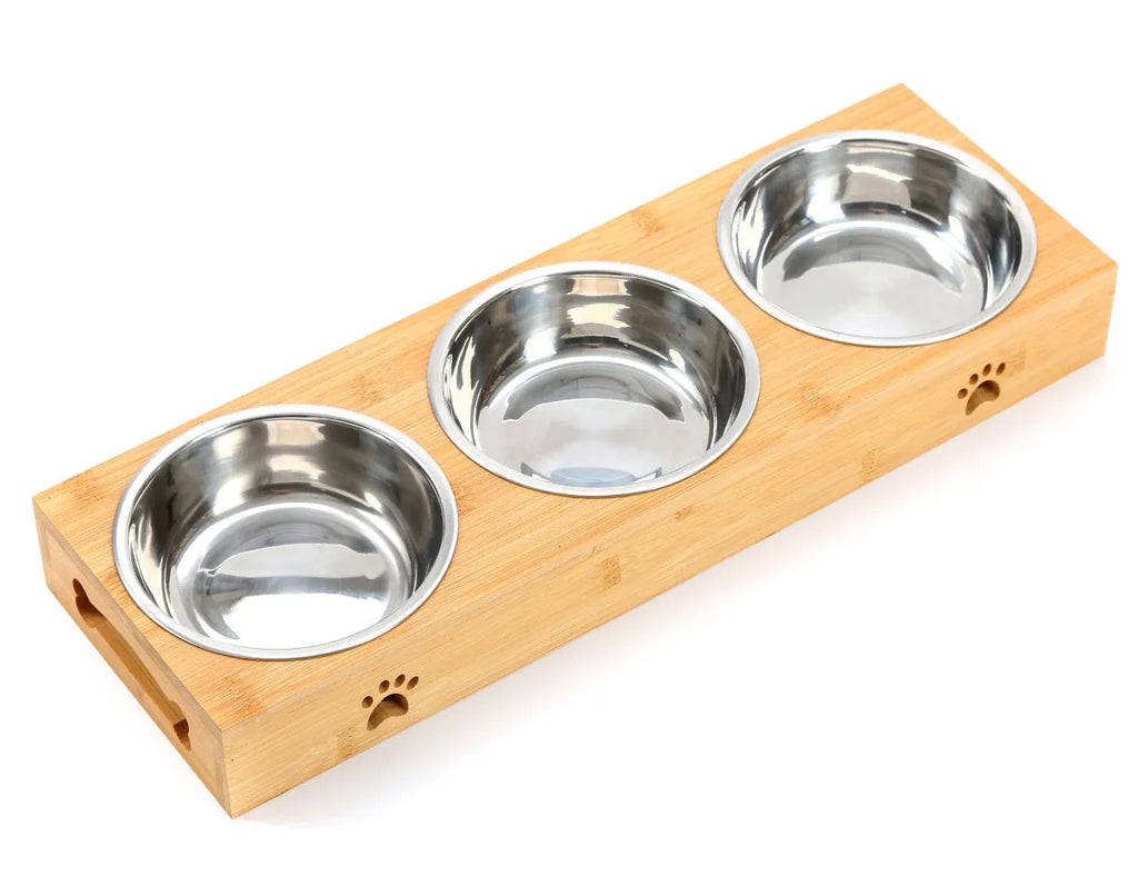 Solid wood pet feeding table with stainless steel bowls in a raised design for cats.