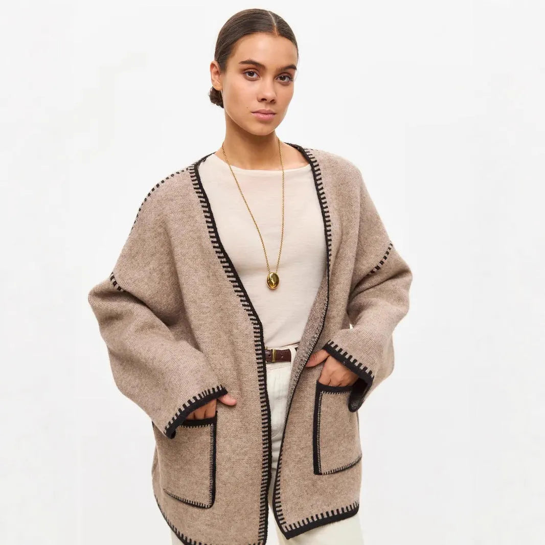 Lace-up front knitted cardigan in a camel colour, shown loose and open over a top.