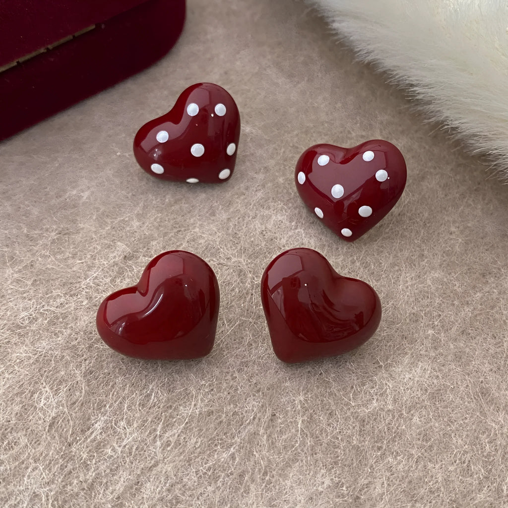 Red drip glaze heart earrings in copper, shown as no-piercing ear clips and stud earrings