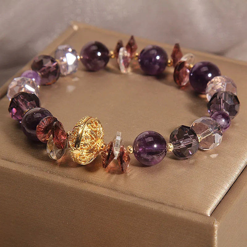 Purple crystal bracelet with pumpkin-shaped beads and rhinestone accents on a wrist.