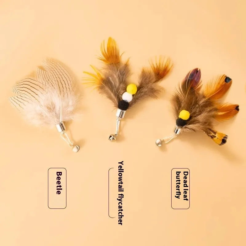 Three steel wire cat toy replacement heads with small flying insect designs on a plain background.