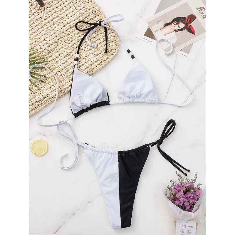 Black and white lace-up bikini swimsuit with triangle cups and adjustable tie-side bottoms